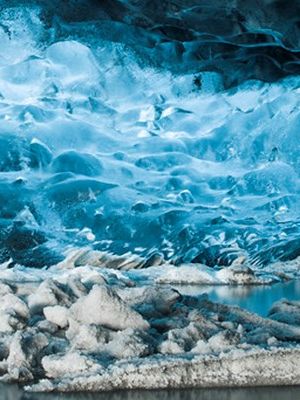 a large ice cave filled with ice and water .