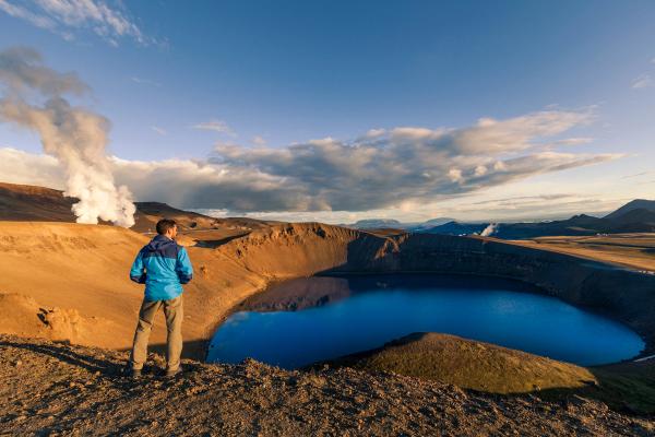 Hiker overlooking a volcanic lake