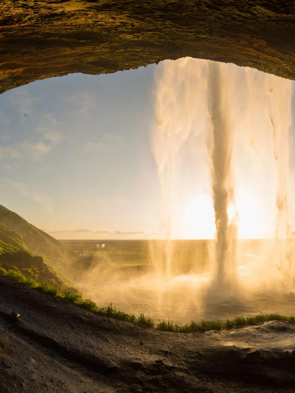 Seljalandsfoss seen from behind during the sunset