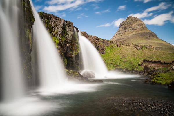 Long exposure of Kirkjufellsfoss waterfall with Kirkjufell mountain in the background.