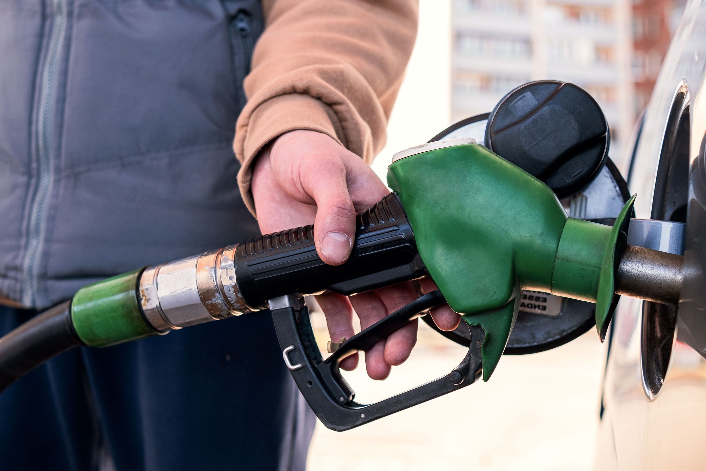 A gray rental car stops at a gas station in the picturesque landscape of Iceland. Gray rental car refueling at a gas station in Iceland.
