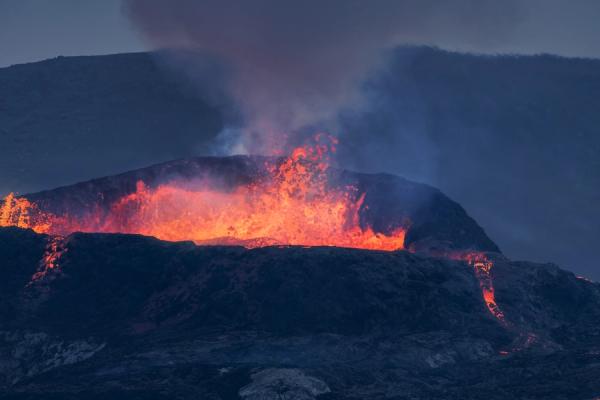 a volcano is erupting with lava coming out of it in iceland.