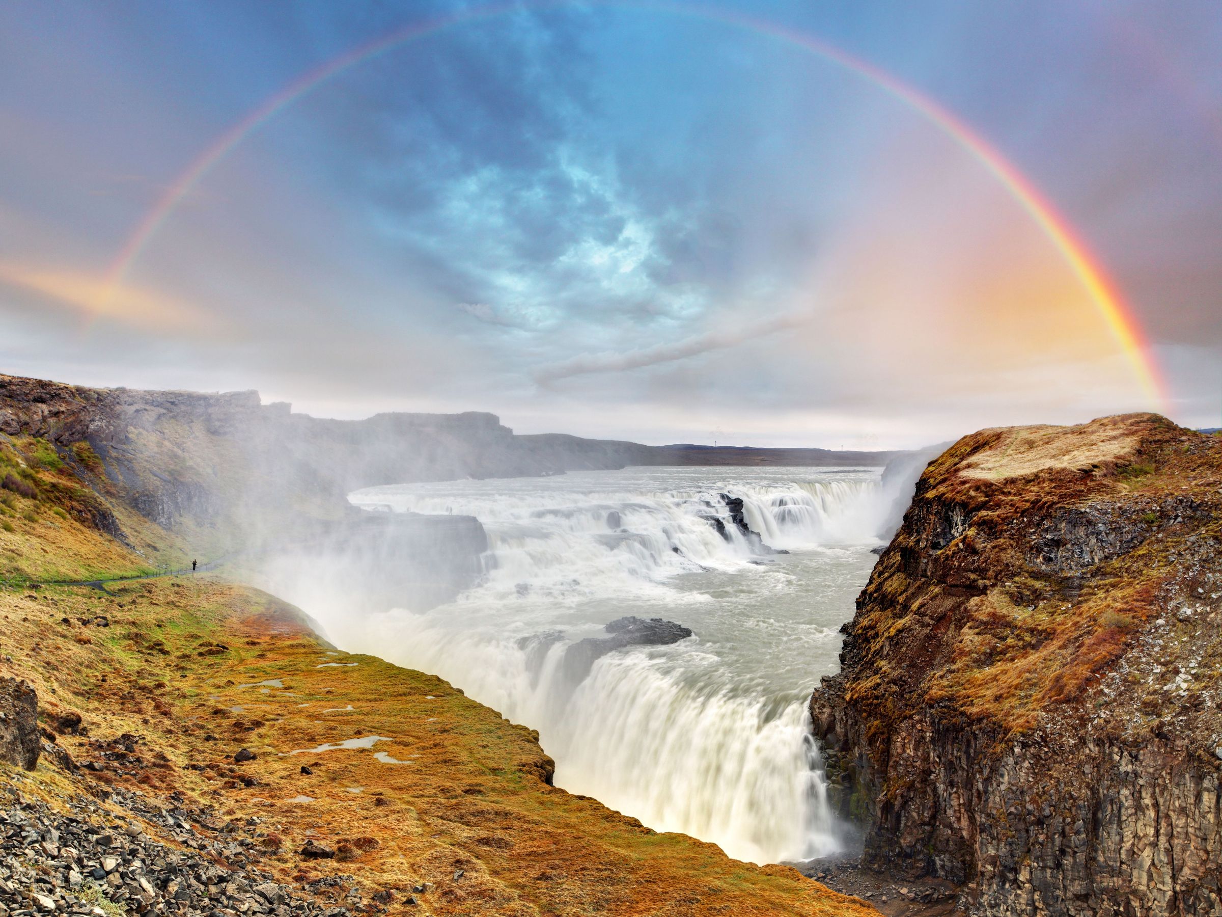 Gullfoss waterfall with a full rainbow above it