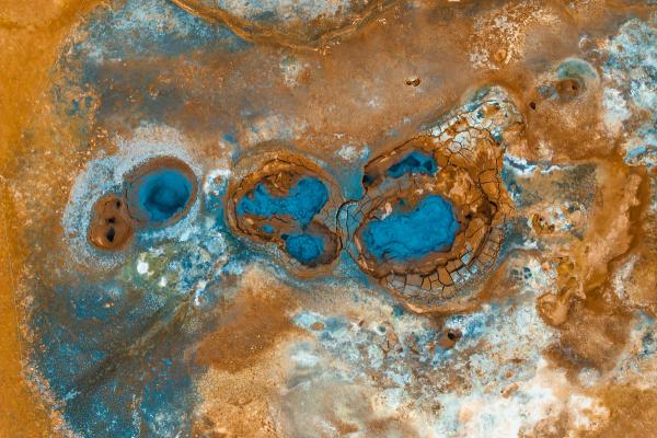 an aerial view of a desert landscape with a lot of water and rocks .