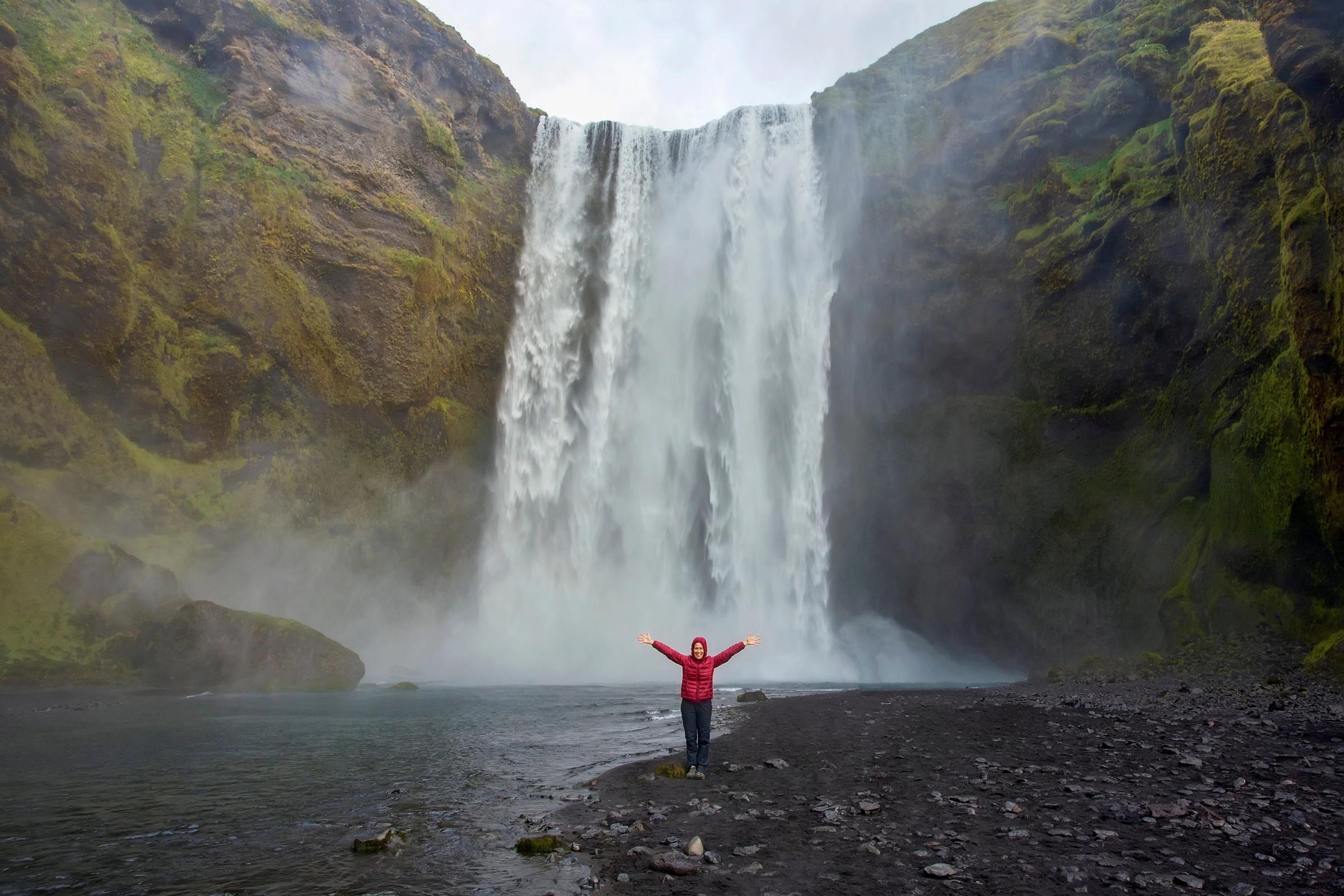 Girl close to Skogafoss waterfall