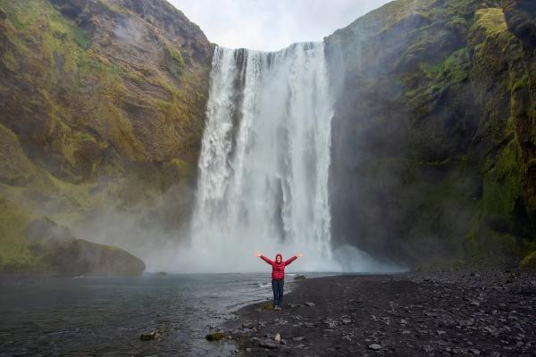 Girl close to Skogafoss waterfall
