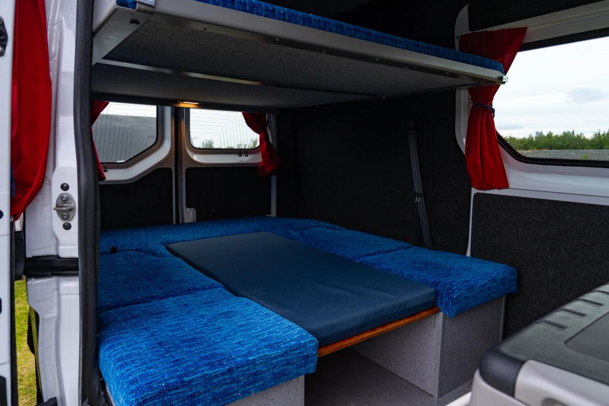 Benches and table made into a lower bed in a 5 person large camper