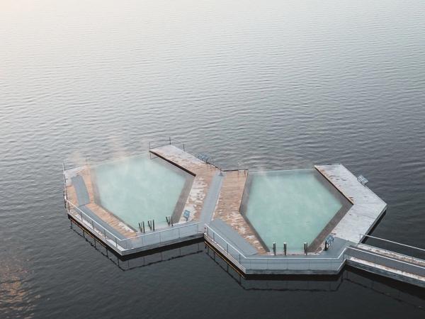 Drone shot of Vök Baths floating pools against the lake