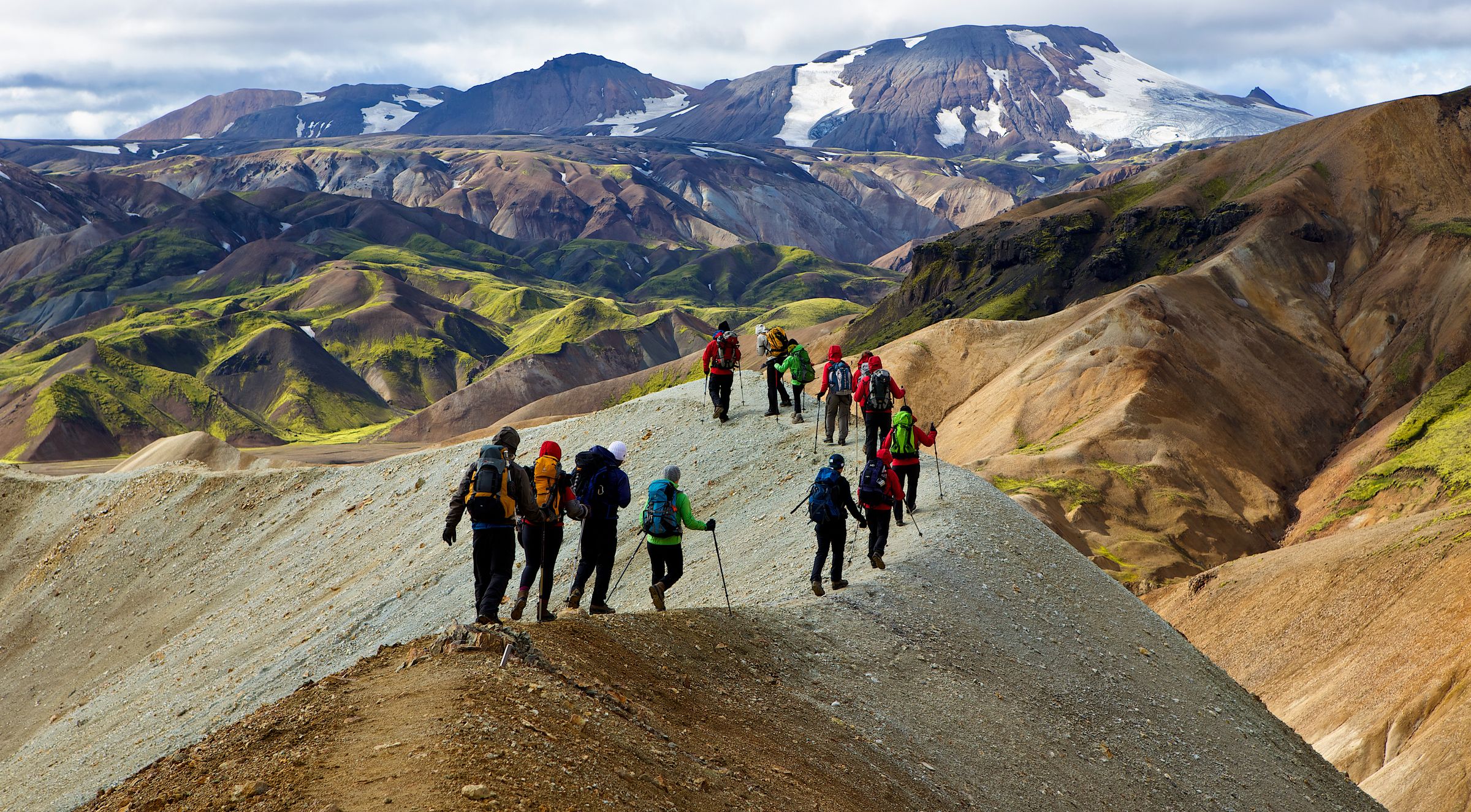 a group of people are hiking up a mountain .