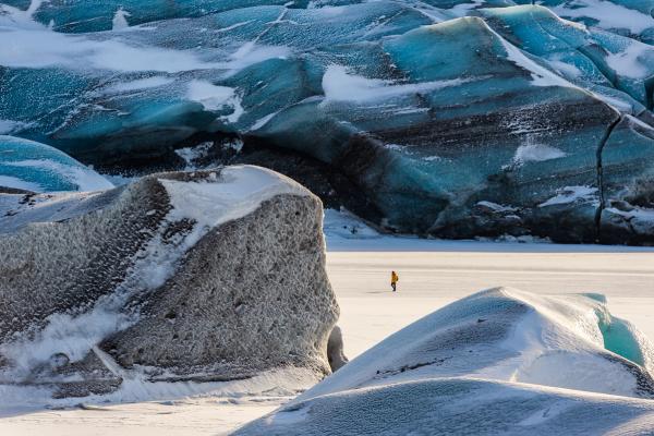 a person walking in a big glacier