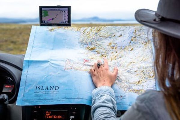 a woman is looking at a map in a car .
