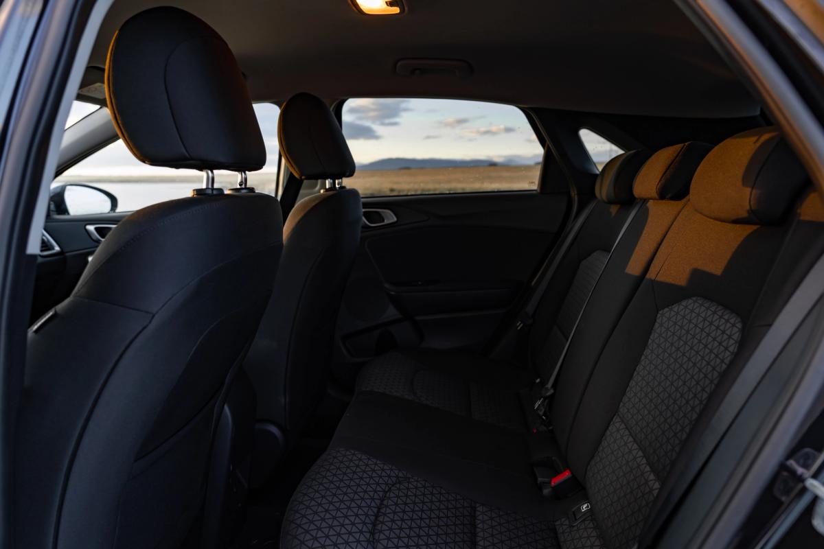 Kia Ceed rear seats with orange accent upholstery viewed from front row