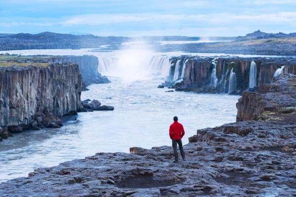 Man watching Selfoss waterfall from the distance