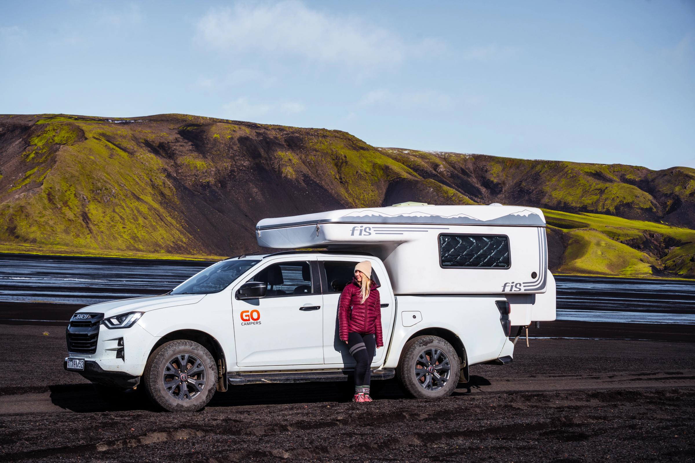 4x4 Camper Side View A 4 person 4x4 campervan parked on black sand beside a river, camper rental Iceland