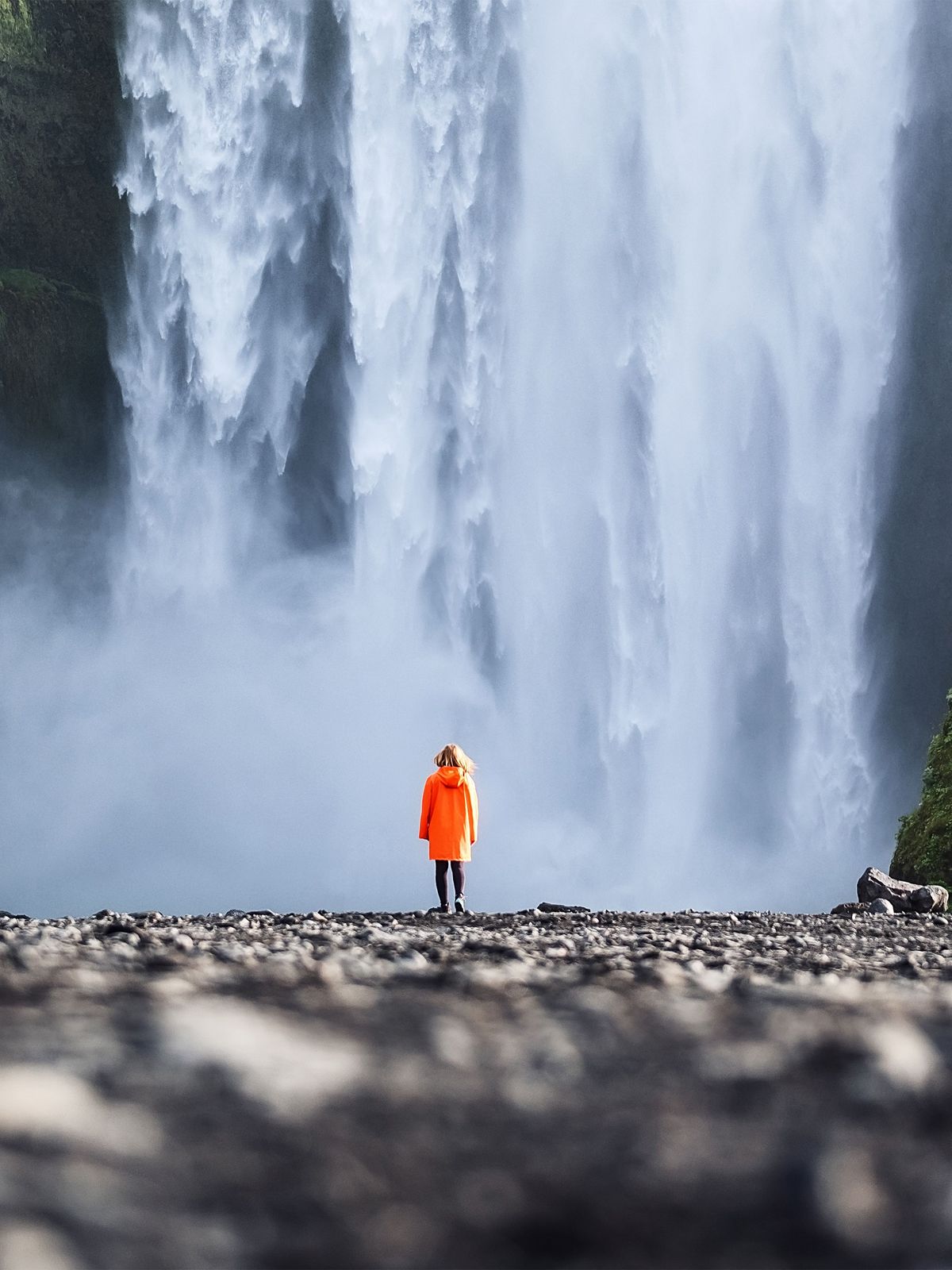 Waterfall in Iceland Girl in front of Skogafoss waterfall
