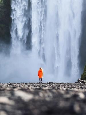 Waterfall in Iceland Girl in front of Skogafoss waterfall