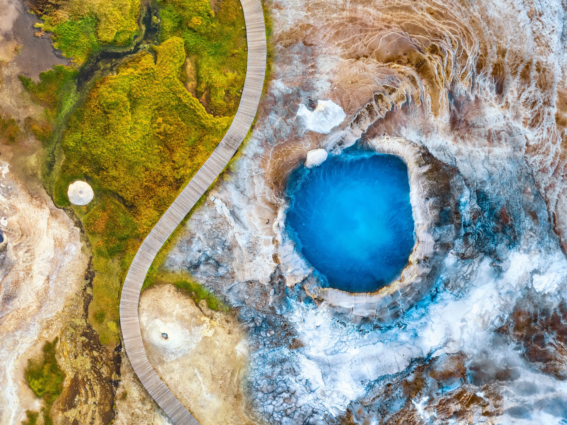 aerial view of a circular blue hot spring