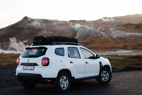 Navigate the rugged terrains of Iceland with ease in our reliable white Duster rental car. White Duster rental car poised for adventure in Iceland.