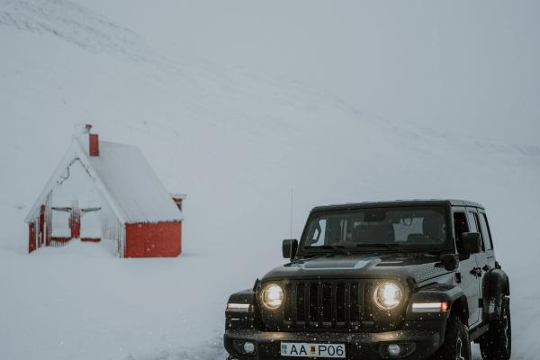 Jeep Wrangler A view of a car driving on a road in Iceland during winter