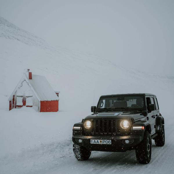 Black jeep in a snowy road