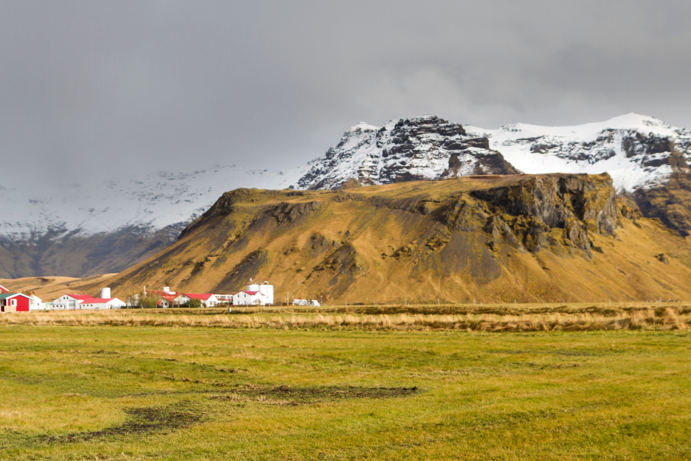 a group of houses at the base of a big mountain