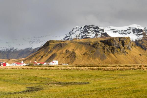 a group of houses at the base of a big mountain