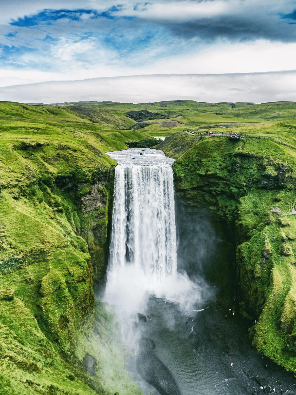 Aerial of Skógafoss Waterll surrounded by green