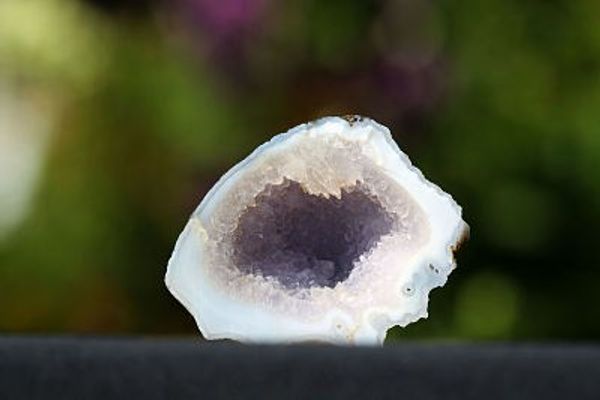 a piece of agate with a hole in the middle is sitting on a table .