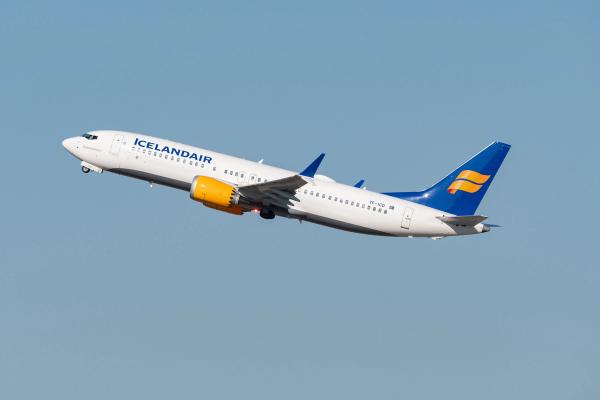 direct flight to Iceland plane of the company "icelandair" in full takeoff, with a blue sky in bottom