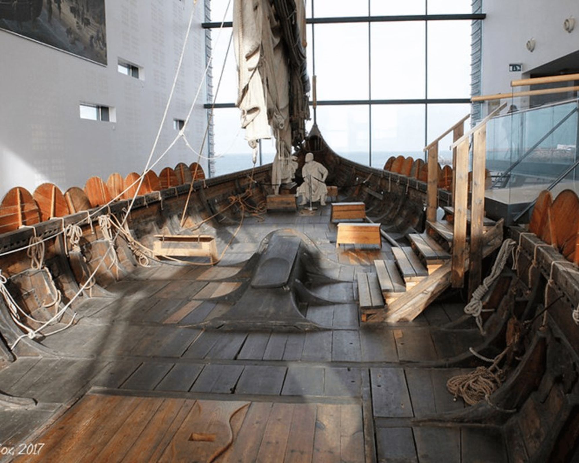 the inside of a boat with a statue of a man on it at Viking world in keflavík iceland.