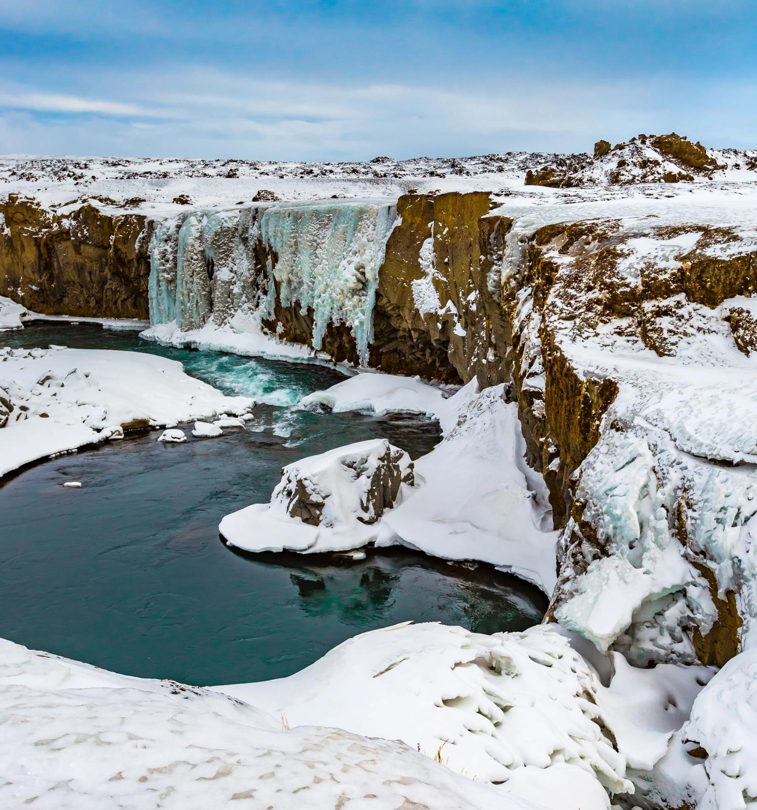 Hrafnabjargafoss Waterfall covered in snow