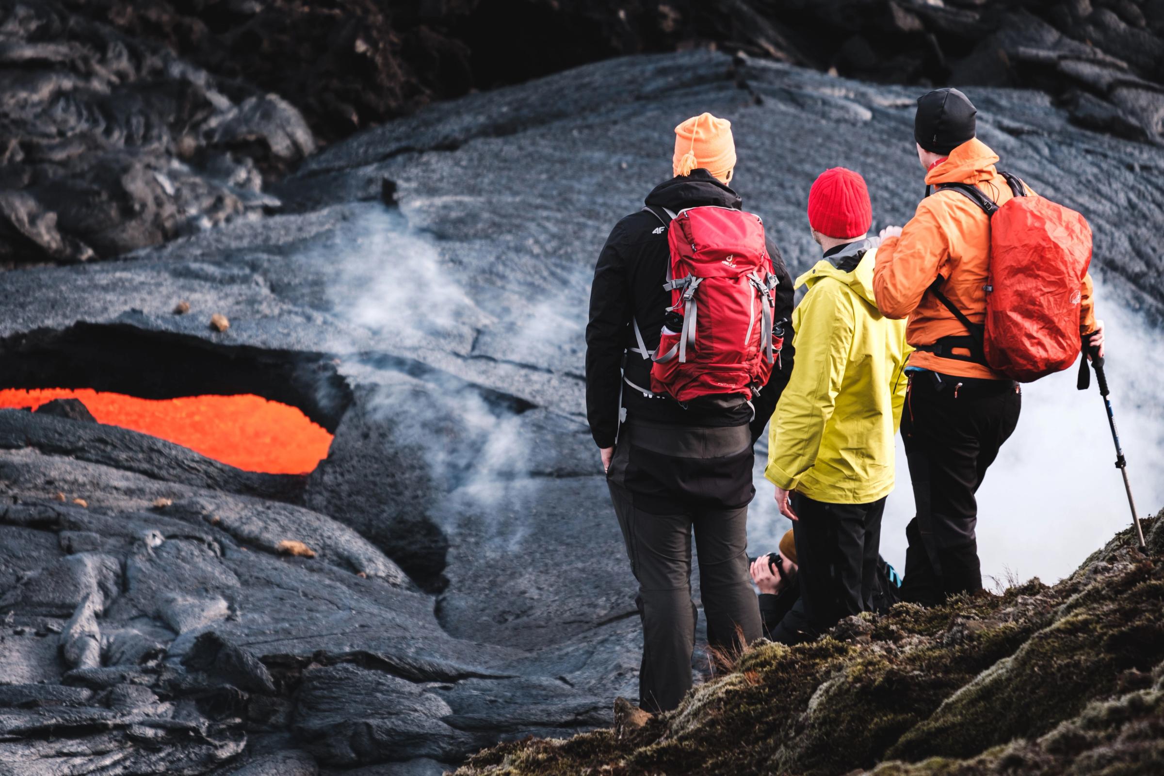 Hikers watching a volcano erupting in Iceland