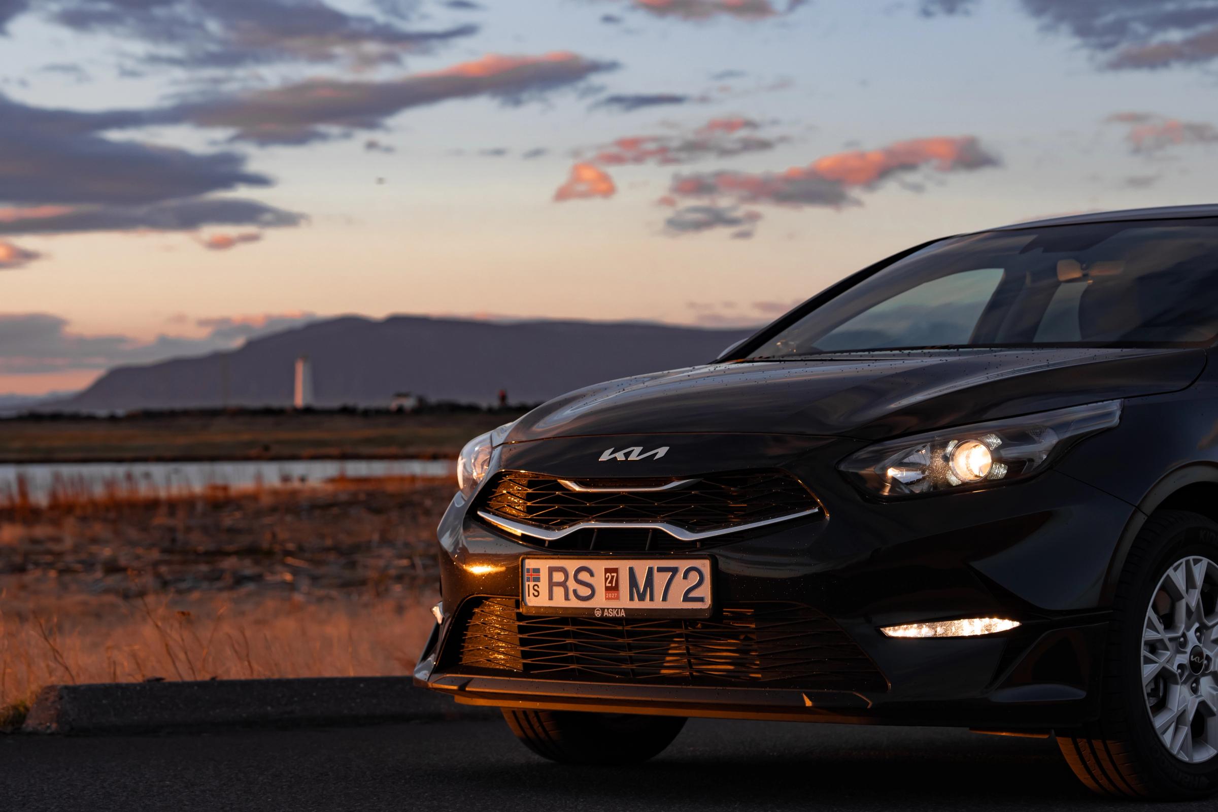 Kia Ceed car rental Iceland front view with headlights on at dusk