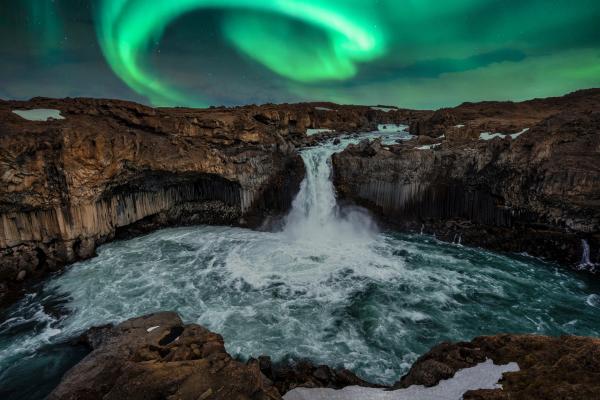 the aurora borealis is shining over a waterfall in iceland at Aldeyjarfoss.