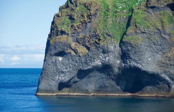 a large rock formation in the middle of the ocean .