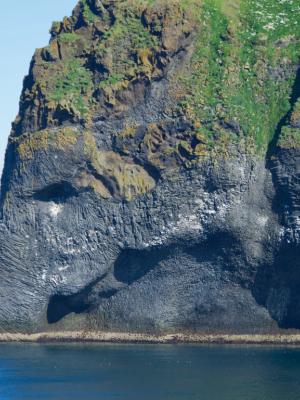 a large rock formation in the middle of the ocean .
