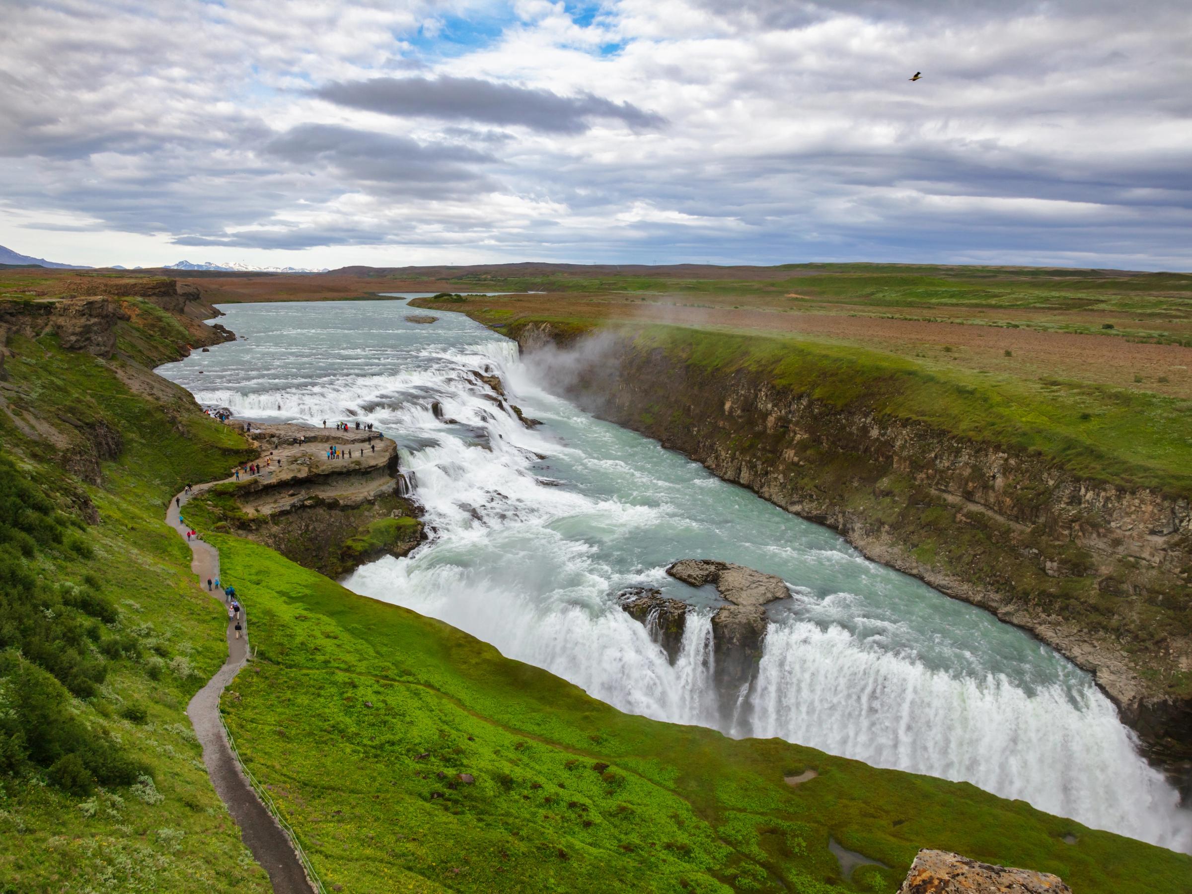 a waterfall in the middle of a river in Iceland