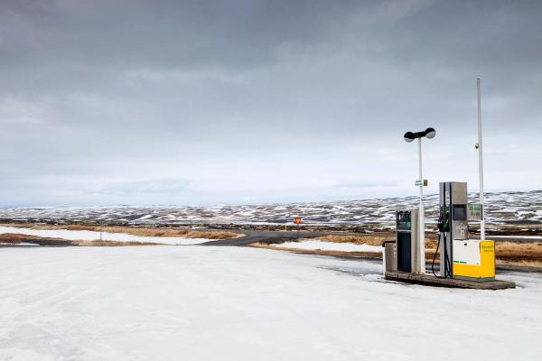 a gas station in the middle of a snowy field .