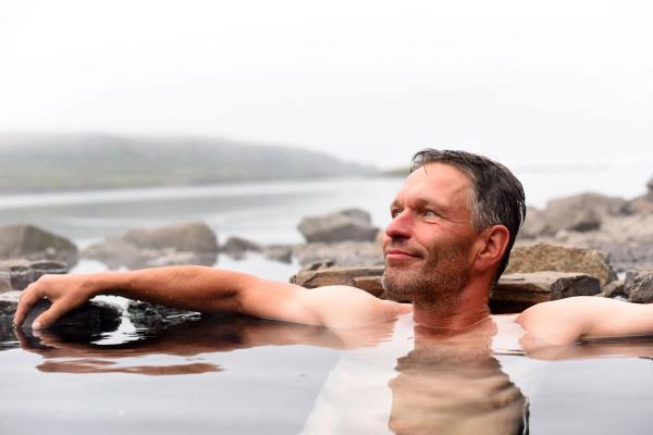 geothermal pools  An Icelander relaxing in a geothermal pools Iceland hot springs