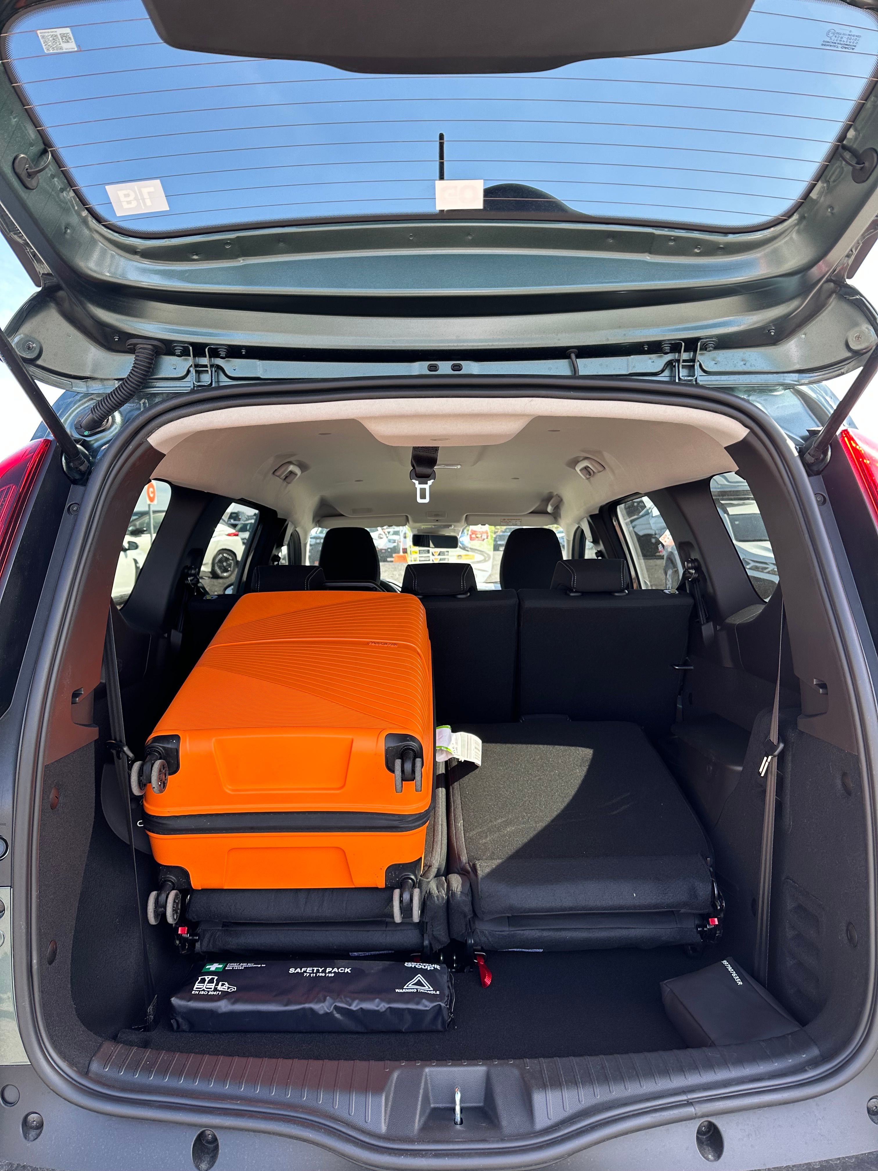 Dacia Jogger trunk with orange suitcase showing available luggage capacity