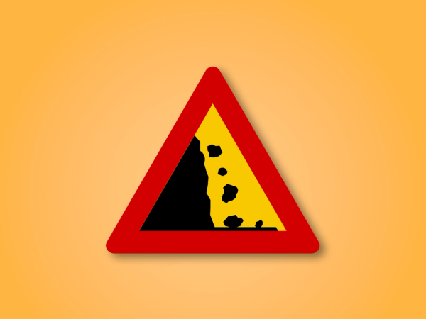 a red triangle with a yellow and black triangle with rocks on it