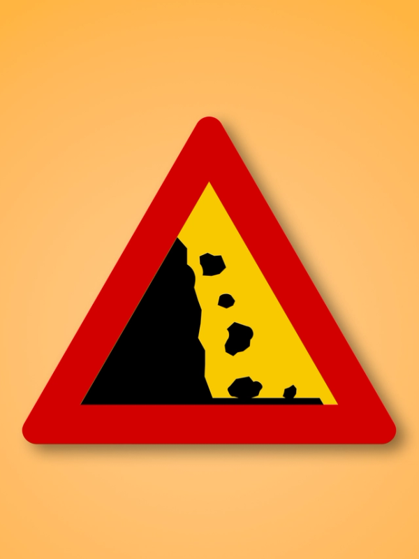 a red triangle with a yellow and black triangle with rocks on it