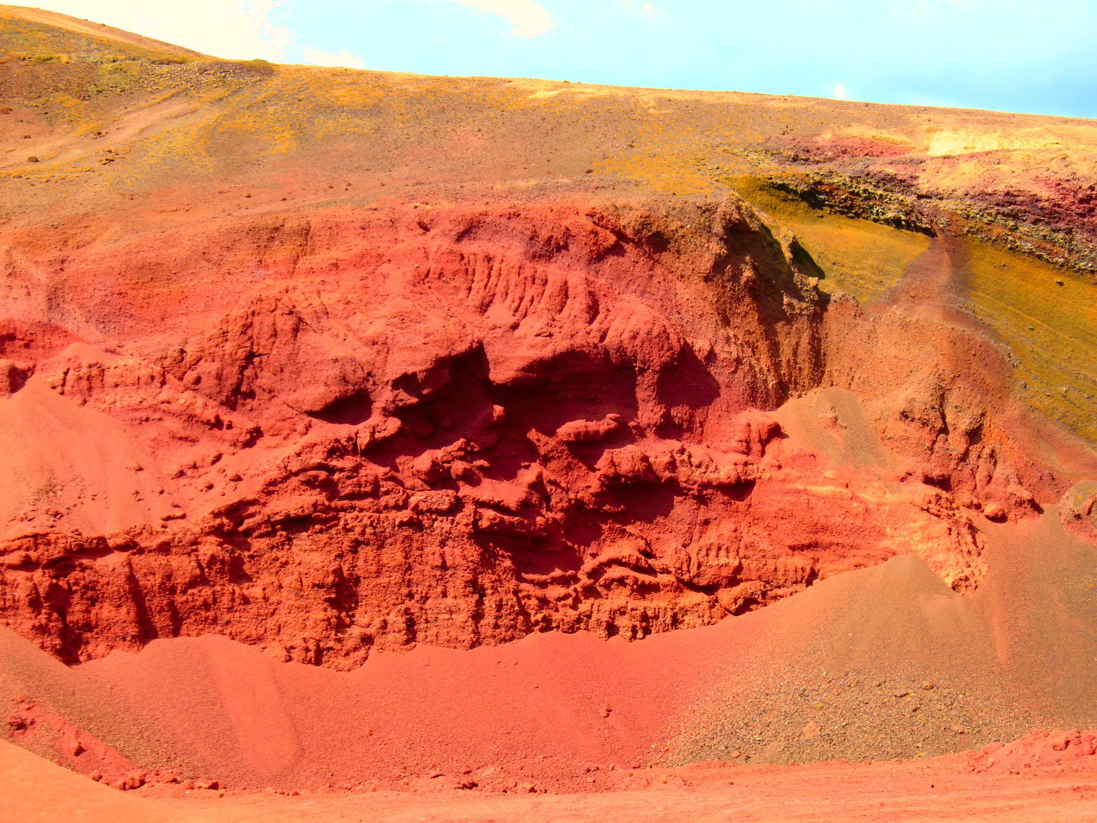 a large hole in the ground in the middle of a desert .