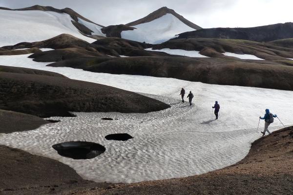 People hiking through a small glacier in Thórsmörk