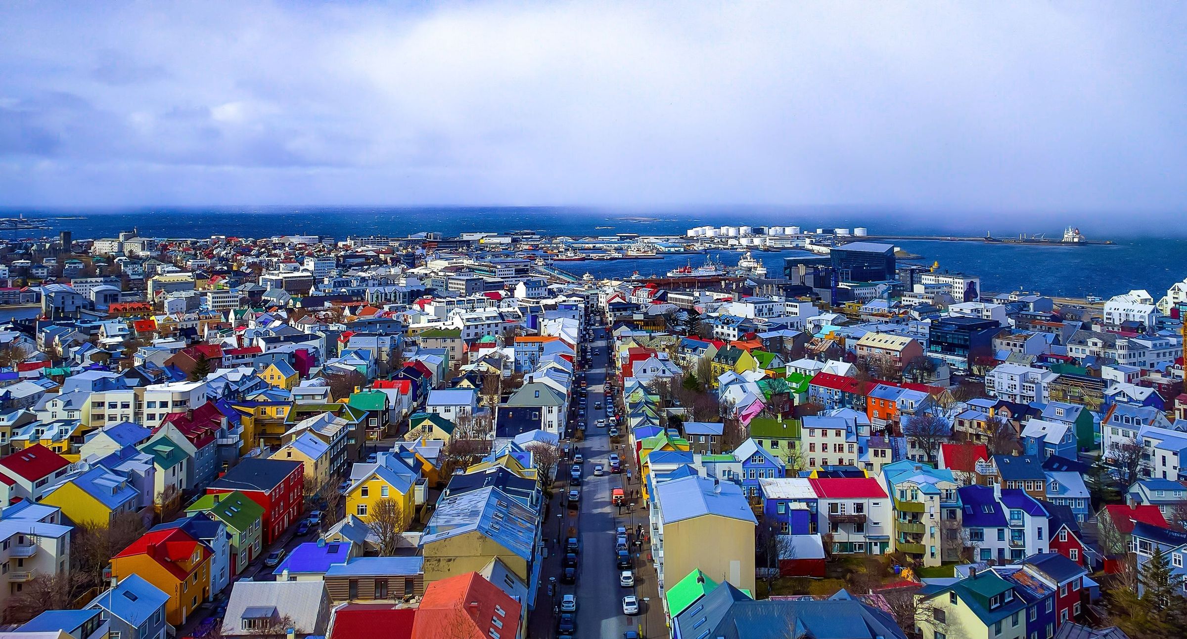 A colorful coastal city on a cloudy day