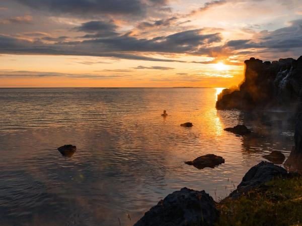 Sun set at Sky Lagoon with one person in the water