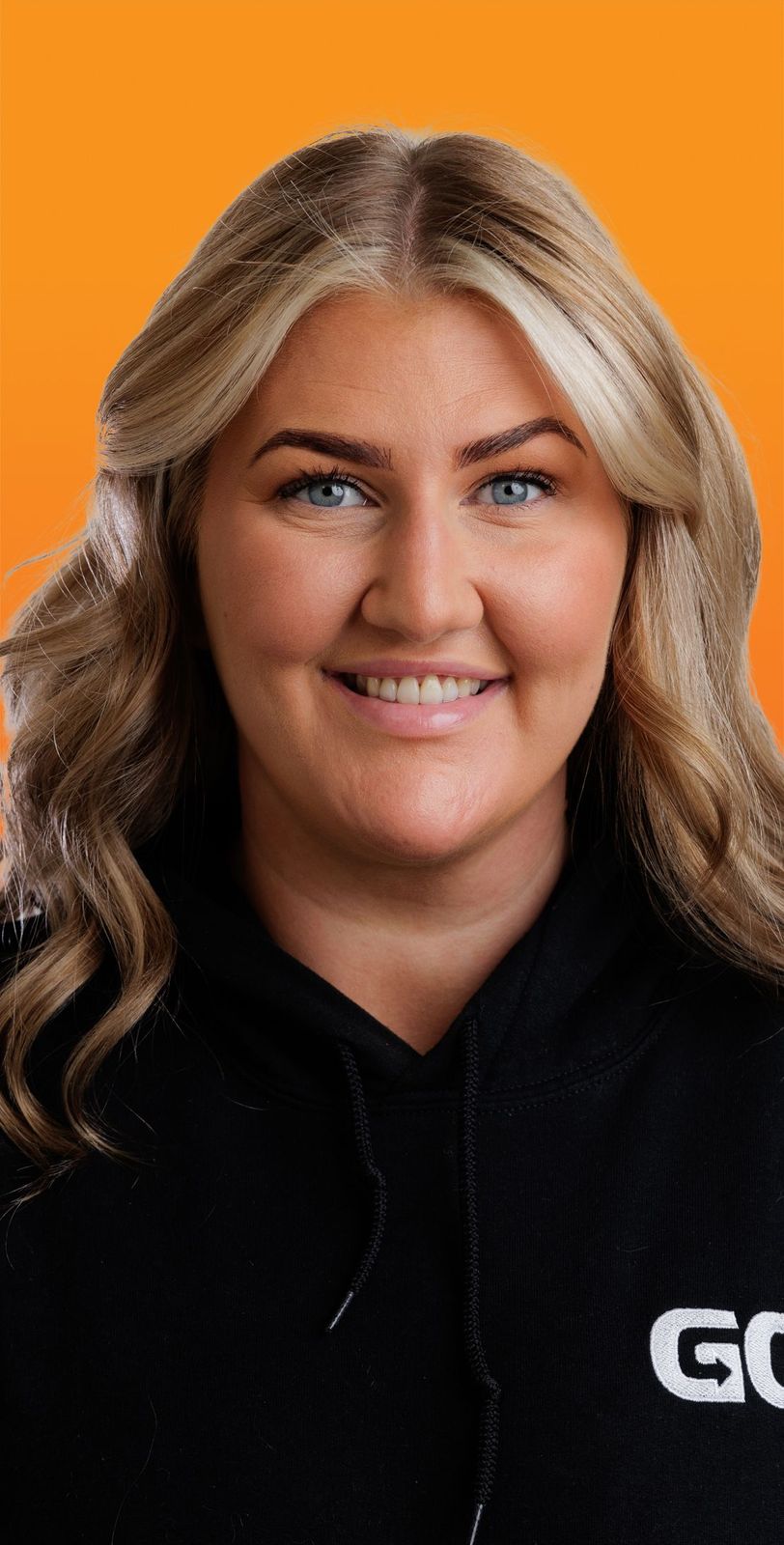 a woman wearing a black hoodie with the word go on it