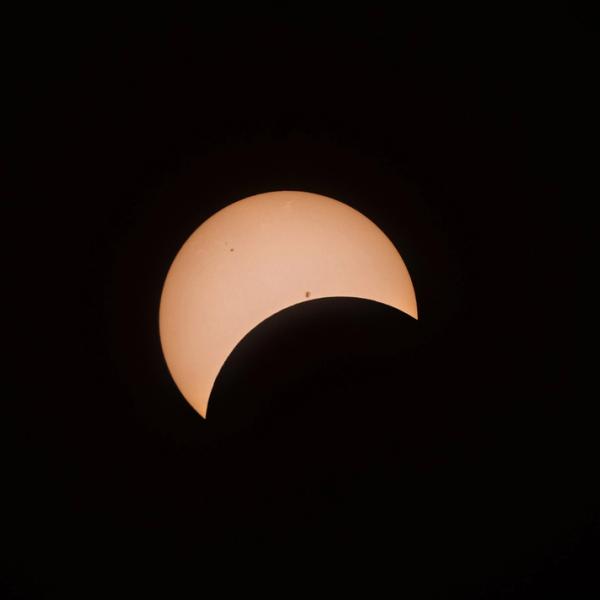 the sun is partially obscured by the moon during an eclipse .