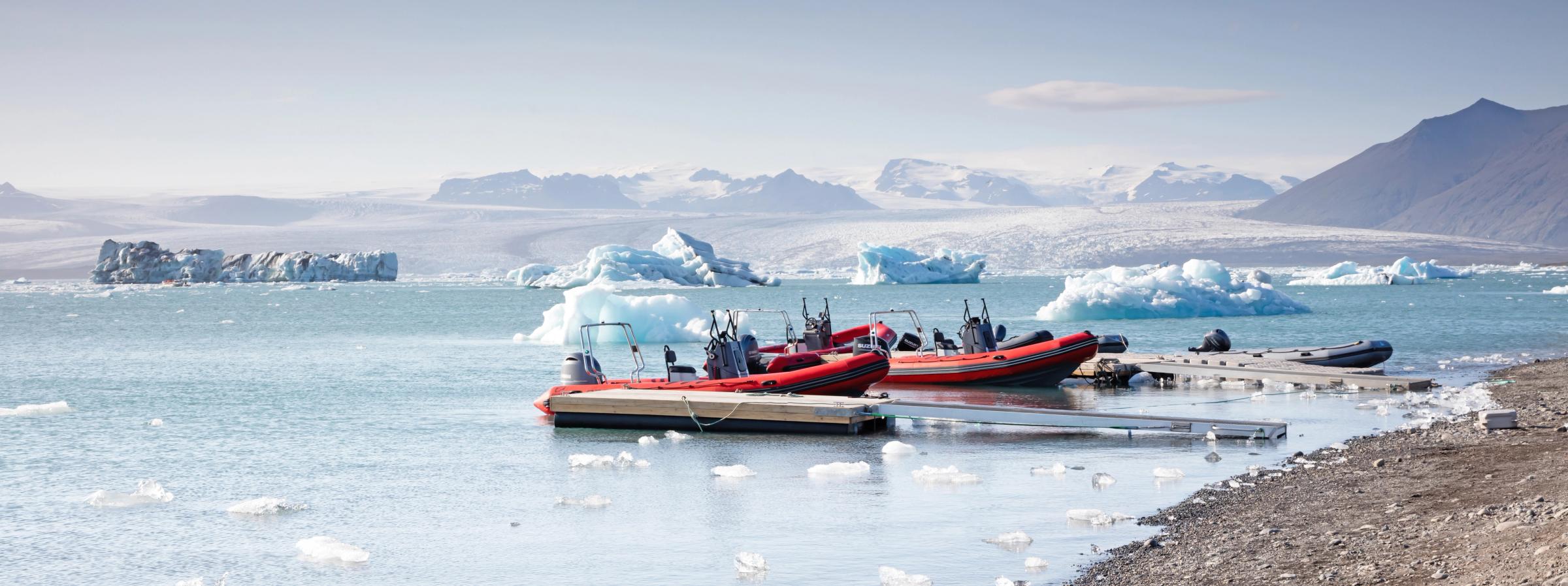 two zodiac boats anchored in a glaciar lagoon