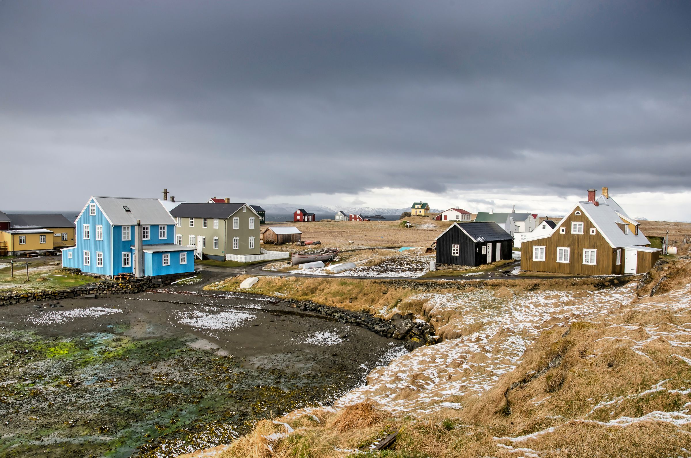 Group of colorful houses under a cloudy sky